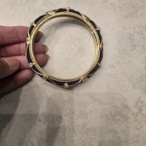 Beautiful gold and black (might be really dark blue) bangle bracelet.